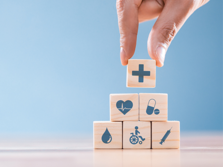 person moving small wooden blocks with health symbols on them