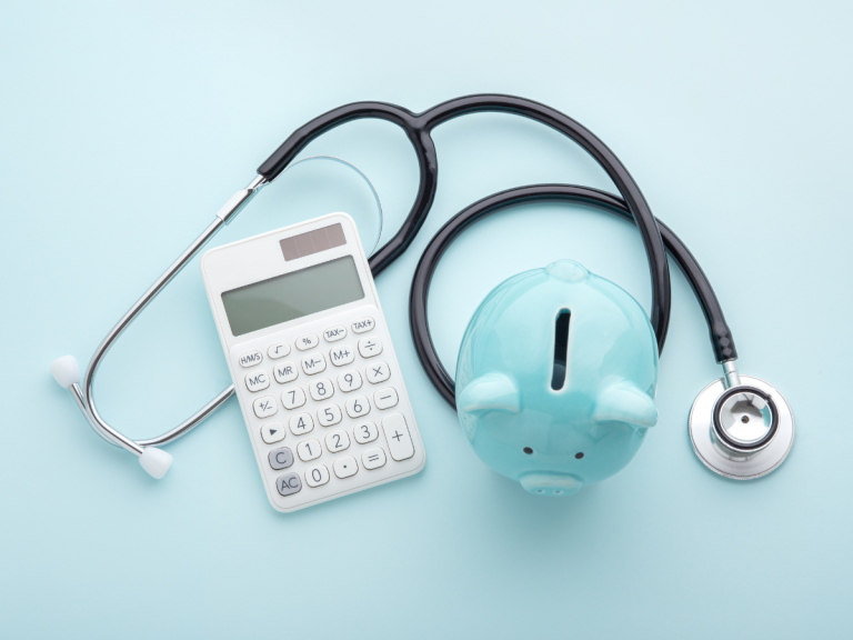 medical instruments next to piggy bank