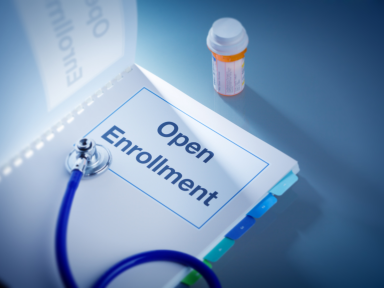 open enrollment on a clipboard with stethoscope and medication